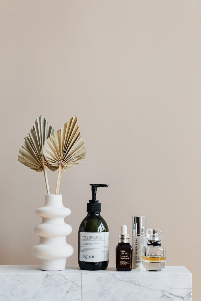 Crafting Captivating Headlines: Your awesome post title goes here Minimalist bathroom shelf featuring skincare bottles and decorative beige vase.